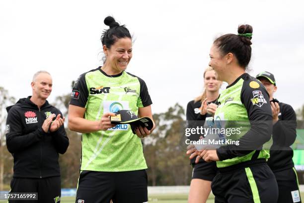 Marizanne Kapp of the Thunder receives her Thunder debut cap from Lauren Smith of the Thunder during the WBBL match between Sydney Thunder and...