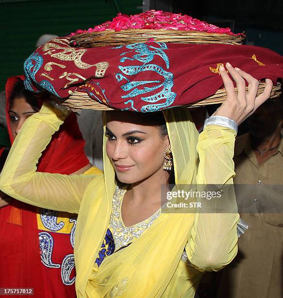 Pakistani actress Veena Malik visits the Ajmer Sharif Dargah to promote her upcoming film 'Real Life of Supermodel' in Ajmer on August 6, 2013. AFP...