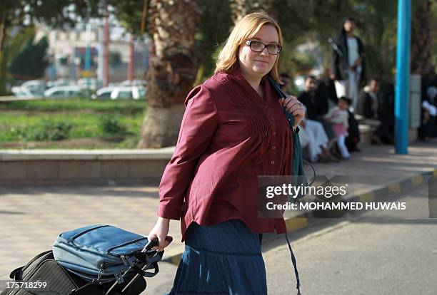 Foreign national walks towards the departure area of Sanaa International Airport before leaving Yemen on August 7, 2013. The United States ordered...