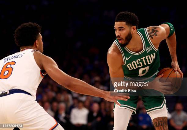 Jayson Tatum of the Boston Celtics takes the ball as Quentin Grimes of the New York Knicks defends at Madison Square Garden on October 25, 2023 in...