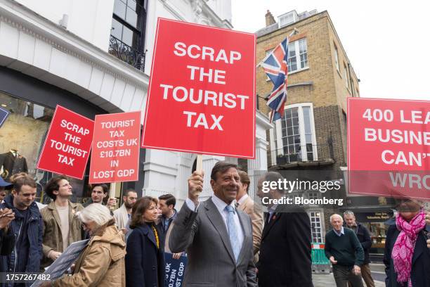Rocco Forte, founder of the Rocco Forte Collection, holds a placard during a protest by business leaders against the "Tourist Tax" in London, UK, on...