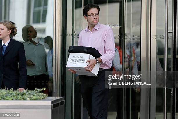 Man carrying a box leaves the Lehman Brothers European Headquarters building in Canary Wharf in east London, on September 15, 2008. The British arm...