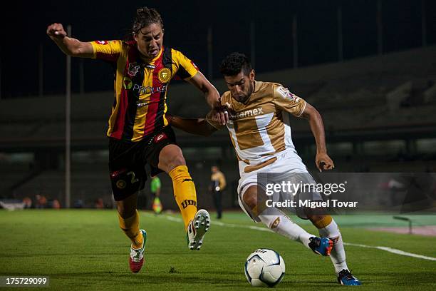 Martin Bravo of Pumas struggles for the ball with Christian Lopez of Leones Negros during a match between Pumas and Leones Negros as part of the Copa...