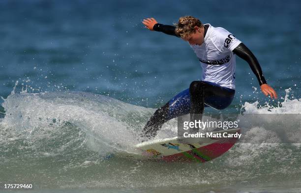 Angus Scotney of Great Britain competes in a pro-juniors heat of the Boardmasters pro-surfing competition on Fistral Beach on August 7, 2013 in...