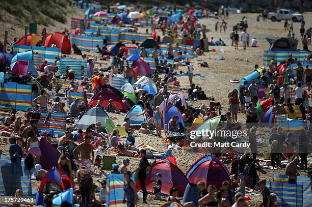 People crowd onto the beach as the pro-juniors heat of the Boardmasters pro-surfing competition takes place on Fistral Beach on August 7, 2013 in...