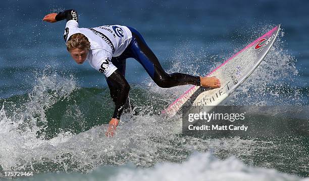 Angus Scotney of Great Britain competes in a pro-juniors heat of the Boardmasters pro-surfing competition on Fistral Beach on August 7, 2013 in...