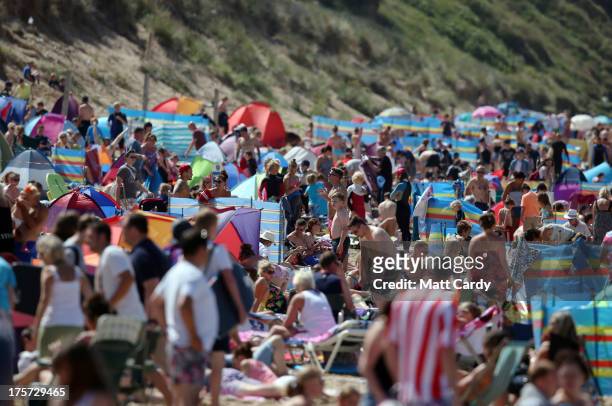 People crowd onto the beach as the pro-juniors heat of the Boardmasters pro-surfing competition takes place on Fistral Beach on August 7, 2013 in...