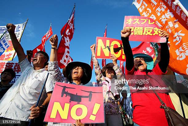 Protesters against Osprey aircrafts deployment to Okinawa demonstrate outside the Nodake Gate of the U.S. Marine Corps Futenma Air Station after the...