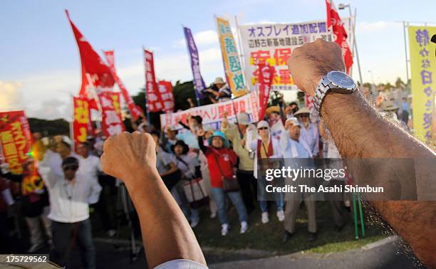 Protesters against Osprey aircrafts deployment to Okinawa demonstrate outside the Nodake Gate of the U.S. Marine Corps Futenma Air Station after the...