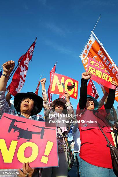 Protesters against Osprey aircrafts deployment to Okinawa demonstrate outside the Nodake Gate of the U.S. Marine Corps Futenma Air Station after the...