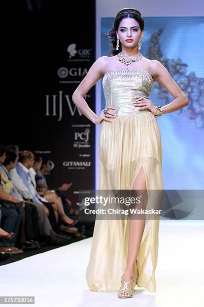 Model walks the runway at the D Navinchandra show on day 4 of India International Jewellery Week 2013 at the Hotel Grand Hyatt on August 7, 2013 in...