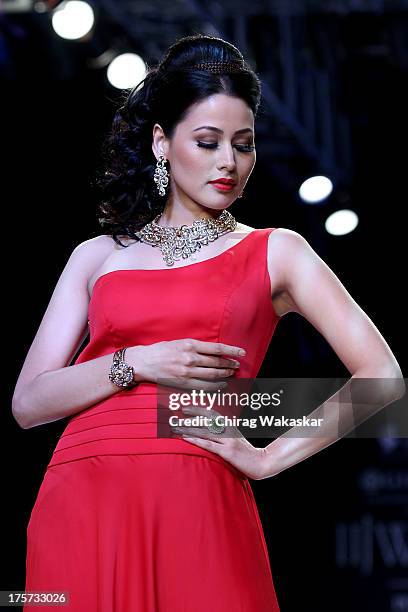 Model walks the runway at the D Navinchandra show on day 4 of India International Jewellery Week 2013 at the Hotel Grand Hyatt on August 7, 2013 in...