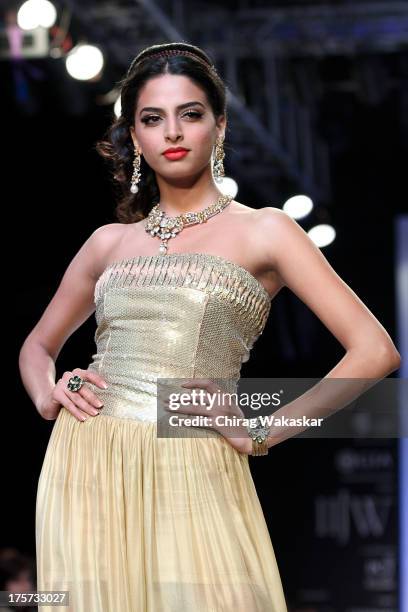 Model walks the runway at the D Navinchandra show on day 4 of India International Jewellery Week 2013 at the Hotel Grand Hyatt on August 7, 2013 in...