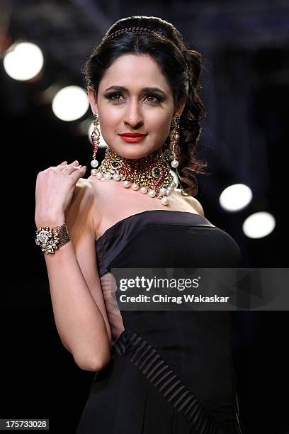 Model walks the runway at the D Navinchandra show on day 4 of India International Jewellery Week 2013 at the Hotel Grand Hyatt on August 7, 2013 in...