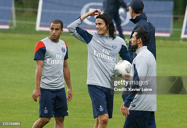 Head coach Laurent Blanc, Lucas Moura, Edinson Cavani and Ezequiel Lavezzi of Paris Saint-Germain react during a training session at Clairefontaine...