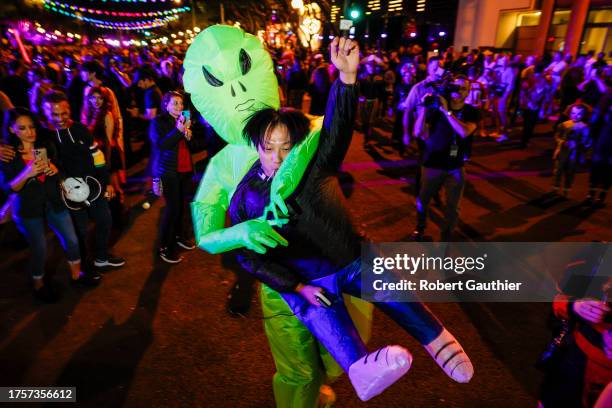West Hollywood, CA, Tuesday, October 31, 2023 - Fanji Zeng and his inflatable alien abducter dance at the West Hollywood Halloween Carnaval.