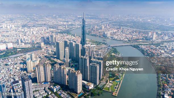 aerial view of early morning at landmark 81 is a super tall skyscraper in center ho chi minh city, vietnam and saigon bridge with development buildings, energy power infrastructure. - vietnam stockfoto's en -beelden