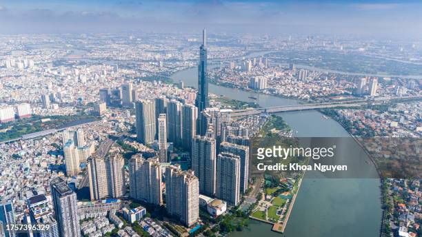 aerial view of early morning at landmark 81 is a super tall skyscraper in center ho chi minh city, vietnam and saigon bridge with development buildings, energy power infrastructure. - saigon river stock pictures, royalty-free photos & images