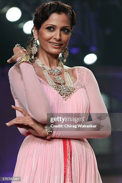 Model walks the runway at the Birdhichand Ghanshyamds Jewellers show on day 4 of India International Jewellery Week 2013 at the Hotel Grand Hyatt on...