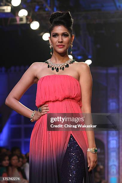 Model walks the runway at the Birdhichand Ghanshyamds Jewellers show on day 4 of India International Jewellery Week 2013 at the Hotel Grand Hyatt on...