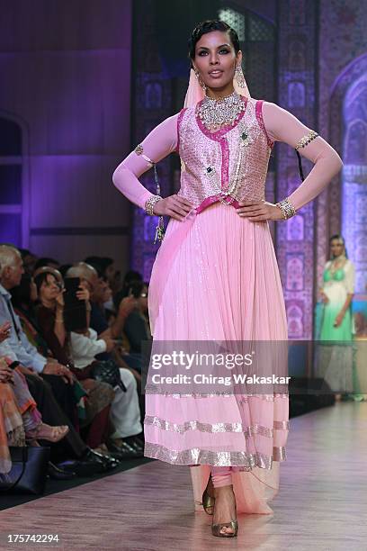 Model walks the runway at the Birdhichand Ghanshyamds Jewellers show on day 4 of India International Jewellery Week 2013 at the Hotel Grand Hyatt on...