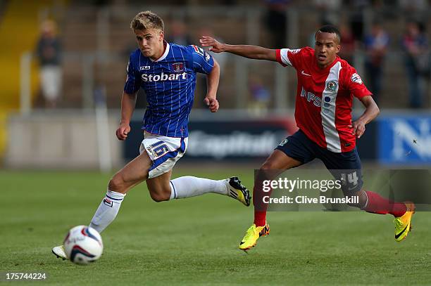 Brad Potts of Carlisle United moves away from Markus Olsson of Blackburn Rovers during the Capital One Cup first round match between Carlisle United...