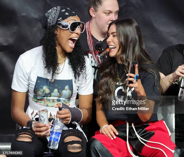 Ja Wilson and Kelsey Plum of the Las Vegas Aces laugh onstage during the team's WNBA championship victory parade and rally at Toshiba Plaza on...