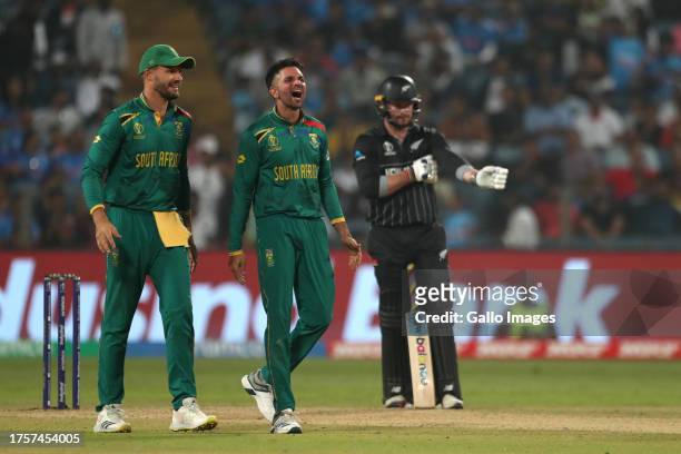 Keshav Maharaj of South Africa celebrates the wicket of New Zealand's Jimmy Neesham during the ICC Men's Cricket World Cup 2023 match between South...