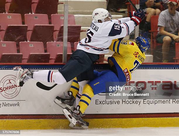Stefan Matteau of Team USA takes a roughing penalty on Lucas Wallmark of Team Sweden during the 2013 USA Hockey Junior Evaluation Camp at the Lake...