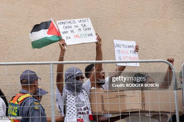 Pro-Palestinian protesters gather outside the Cape Town City Hall, which is being used as a venue for the South African Parliament, in Cape Town on...
