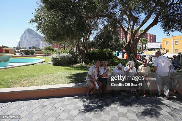 Old men relax in the shade of a tree near the border between Spain and Gibraltar on August 7, 2013 in La Linea de la Concepcion, Spain. Following...