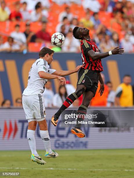 Mbaye Niang of AC Milan goes for a header against Todd Dunivant of Los Angeles Galaxy during the International Champions Cup Third Place Match at Sun...