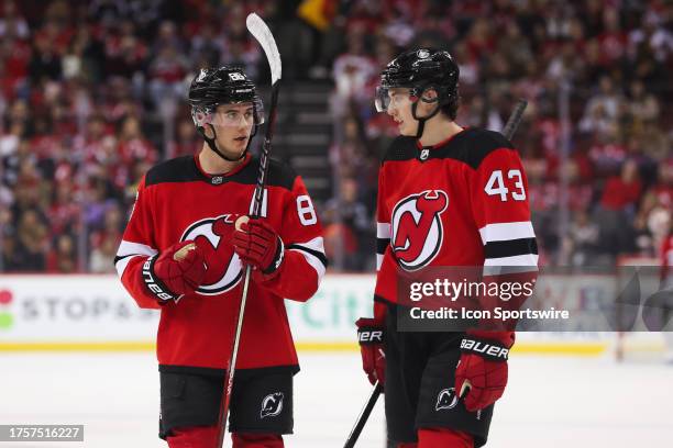 New Jersey Devils center Jack Hughes and New Jersey Devils defenseman Luke Hughes chat during a game between the Minnesota Wild and New Jersey Devils...