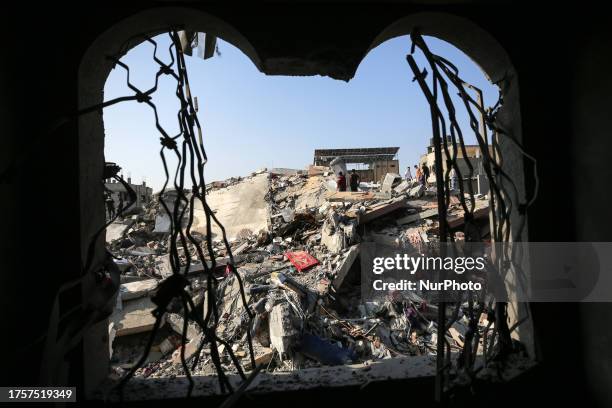 Palestinians search for survivors in the rubble of a building in the Nuseirat refugee camp, in the central Gaza Strip on November 1 amid ongoing...