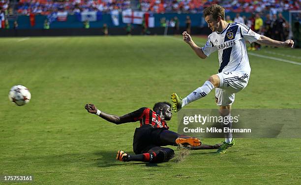 Mbaye Niang of AC Milan dives for the ball against Sean Franklin of Los Angeles Galaxy during the International Champions Cup Third Place Match at...