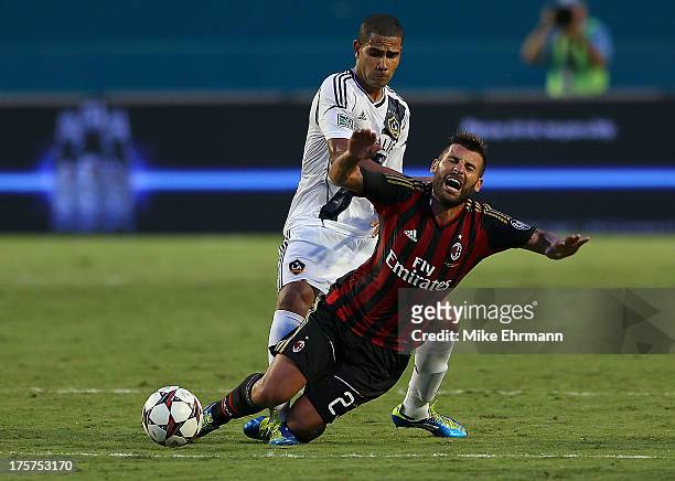 Antonio Nocerino of AC Milan is tripped by Leonardo of Los Angeles Galaxy during the International Champions Cup Third Place Match at Sun Life...