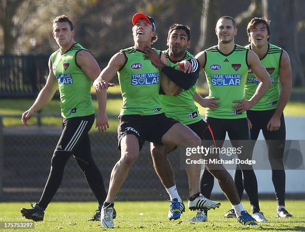 Jake Melskham and Nathan Lovett-Murray contest for the ball during a closed Essendon Bombers training session at Windy Hill on August 8, 2013 in...