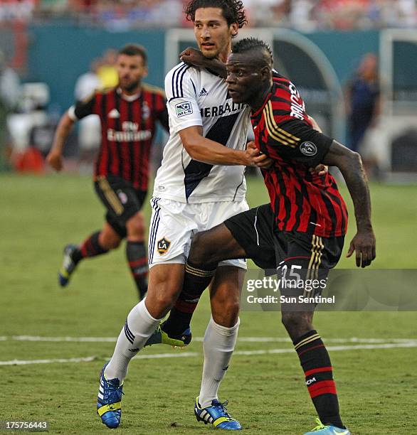 Milan's Mario Balotelli, right, tries to break free of Los Angeles Galaxy defender Omar Gonzalez in first-half action in the third-place game of the...