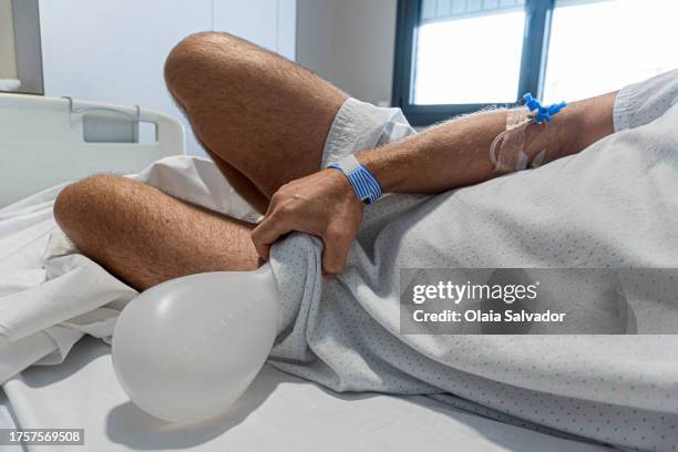 a man lying down using a urinate bottle - body lying down stock pictures, royalty-free photos & images