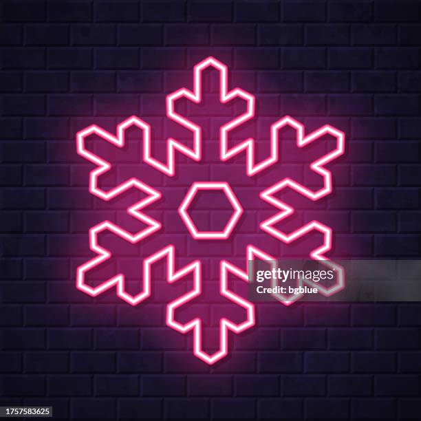 snowflake. glowing neon icon on brick wall background - blue brick wall stock illustrations