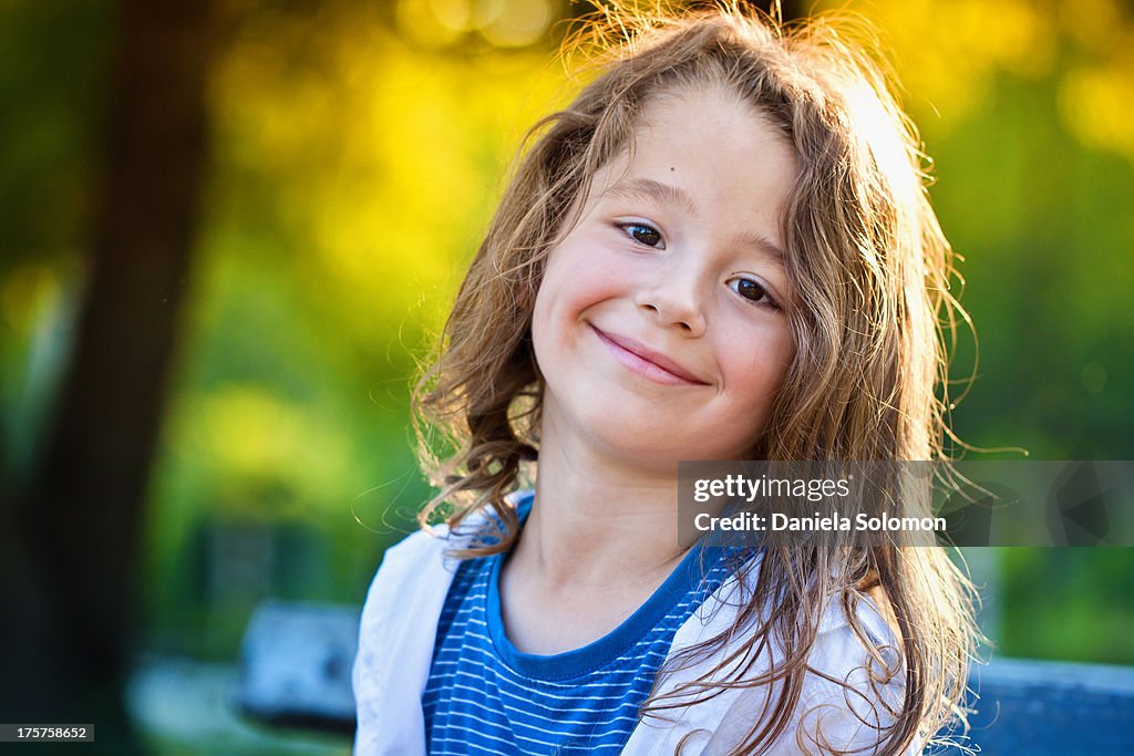 Boy with long hair, smiling