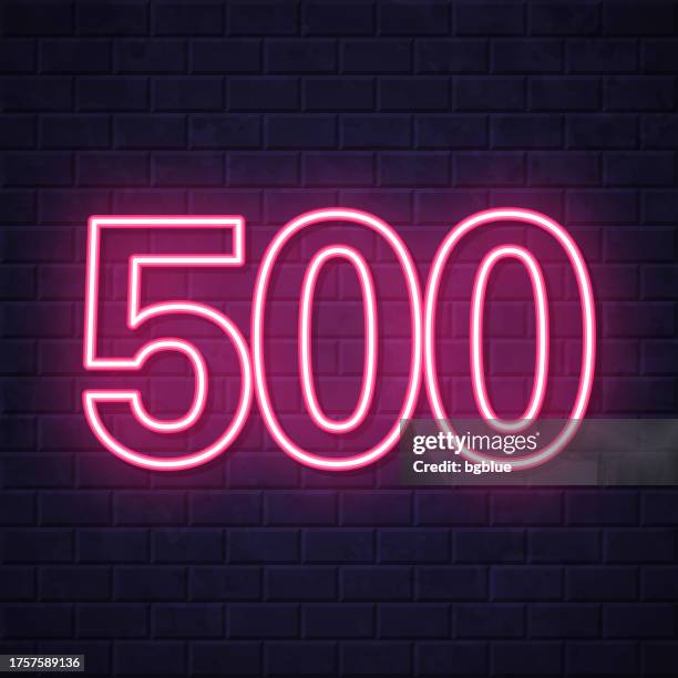 500 - five hundred. glowing neon icon on brick wall background - number 500 stock illustrations