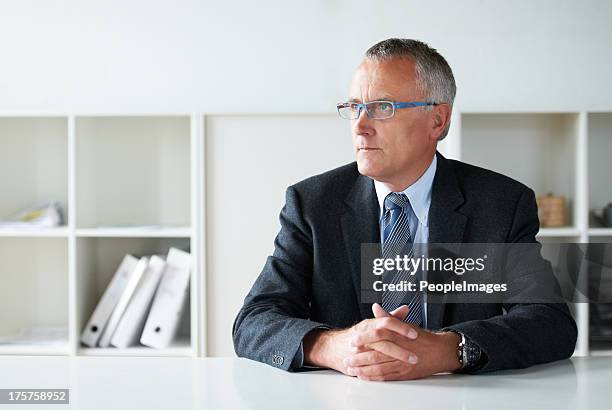 contemplating his company's next move - only men boardroom stock pictures, royalty-free photos & images