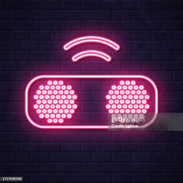 wireless speaker. glowing neon icon on brick wall background - using smart speaker stock illustrations