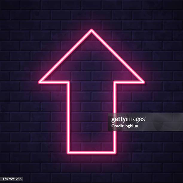 up arrow. glowing neon icon on brick wall background - up arrow stock illustrations