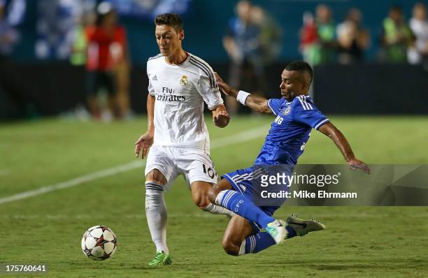 Mesut Ozil of Real Madrid and Ashley Cole of Chelsea fight for a ball during International Champions Cup Championship match at Sun Life Stadium on...