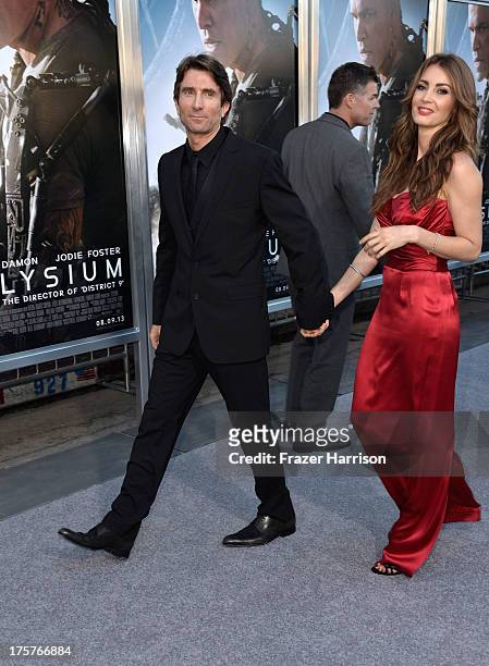 Actor Sharlto Copley and guest arrive at the Premiere of TriStar Pictures' "Elysium" at Regency Village Theatre on August 7, 2013 in Westwood,...