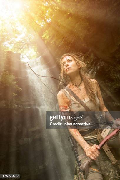 female heroine in the jungle hunting with pick axe - blood stream stock pictures, royalty-free photos & images