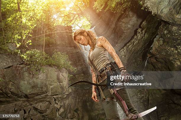 female heroine in the jungle hunting with pick axe - heldin stockfoto's en -beelden