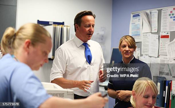 Prime Minister David Cameron talks to staff during a visit to the Salford Royal Hospital accident and emergency department on August 8, 2013 in...